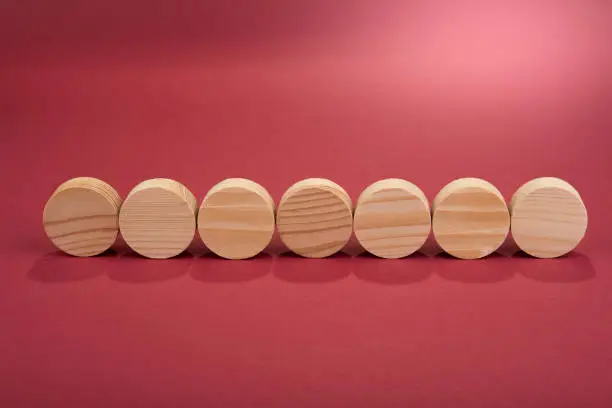 Blank wooden circles for conceptual sign on a red