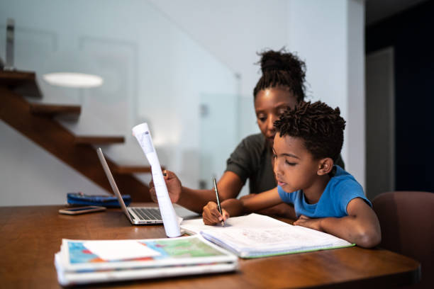 istock Mother helping son with homework at home 1281094785