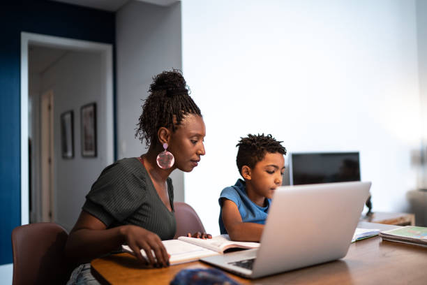 istock Mother helping son with homework at home 1281094867