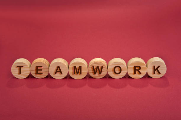 istock Teamwork sign on a wooden circles on a red 1281095248