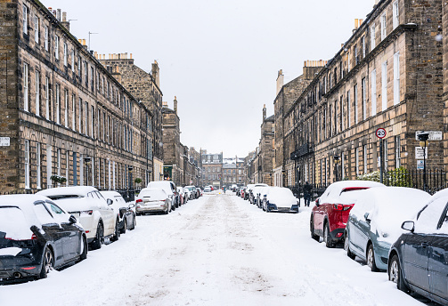 Heavy snow covering the streets and cars in Edinburgh's New Town.