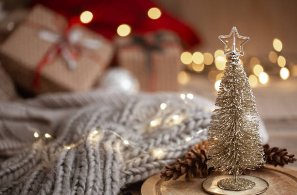 istock Christmas background with a small decorative Christmas tree in the foreground. Festive comfort concept. 1281096515
