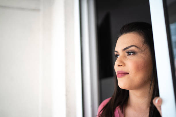 istock Thoughtful transgender woman looking at view at home 1281097868