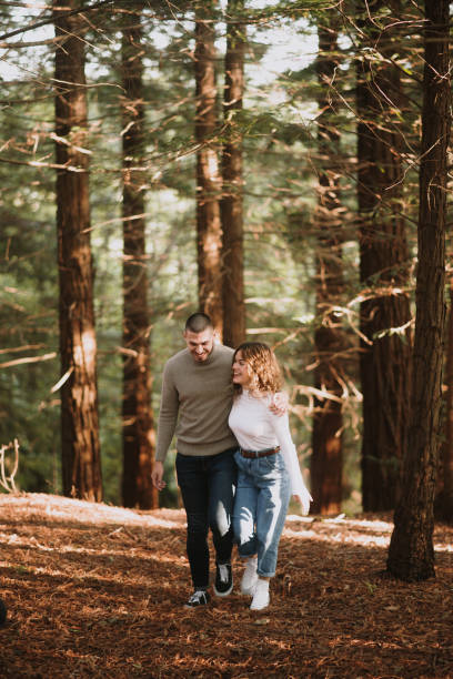 istock Young couple walking in a forest 1281098106