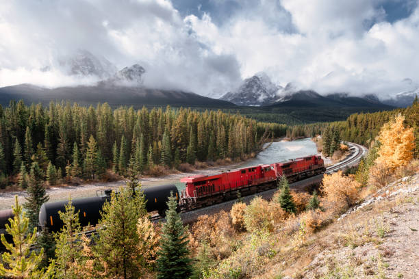 istock Red long freight train on railway passing through autumn valley with mountain at Morant's Curve 1281099760