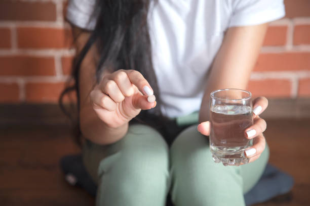 istock young woman take medicine 1281100003