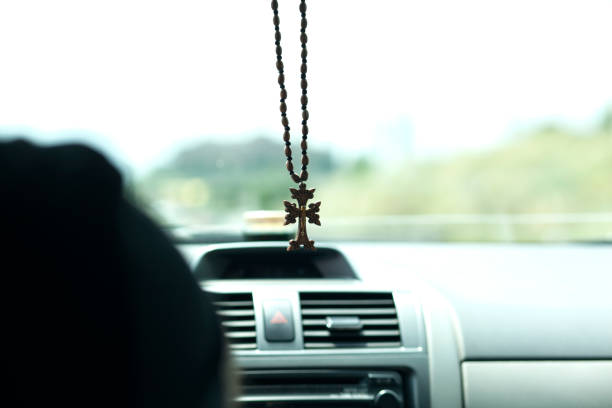 istock wooden cross in car 1281100019
