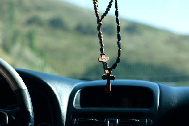 istock wooden cross in car 1281100024