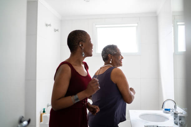 Mother and daughter dancing in the bathroom