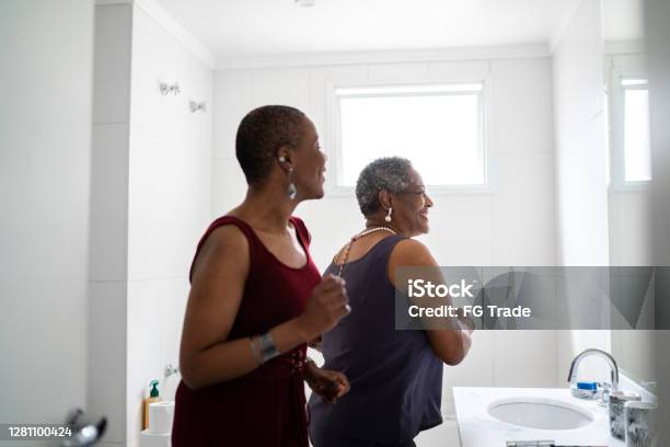 Mother And Daughter Dancing In The Bathroom Stock Photo - Download Image Now - Bathroom, Dancing, Senior Adult