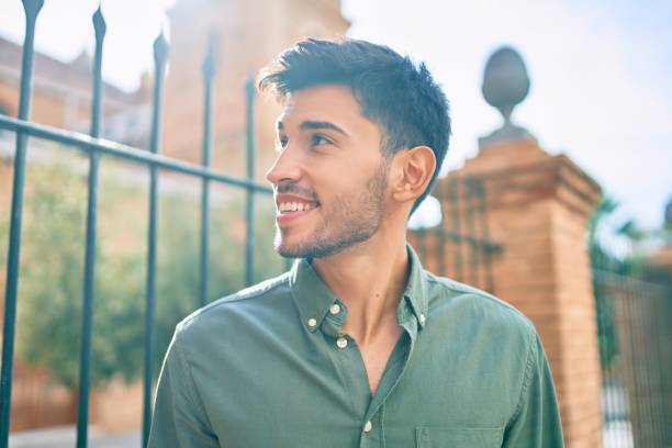 istock Young latin man smiling happy walking at the city. 1281101821