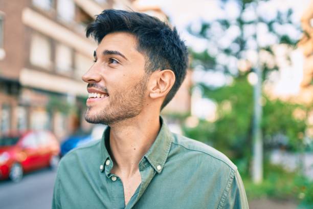istock Young latin man smiling happy walking at the city. 1281101825