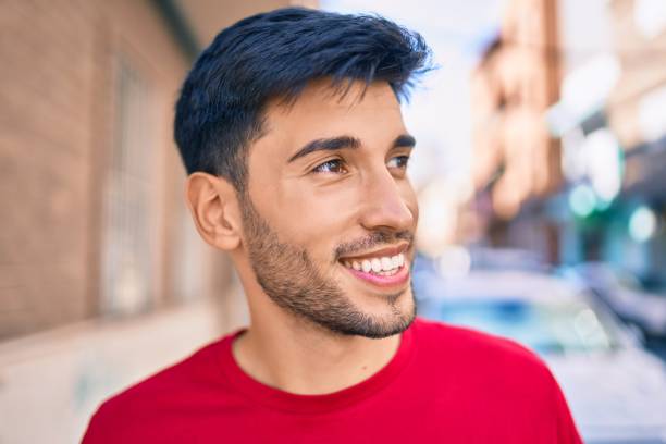 istock Young latin man smiling happy walking at the city. 1281101838
