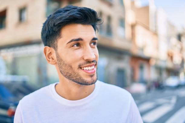 istock Young latin man smiling happy walking at the city. 1281101876