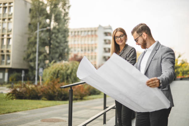 istock Civil architects reading document and checking new project outdoors 1281103528
