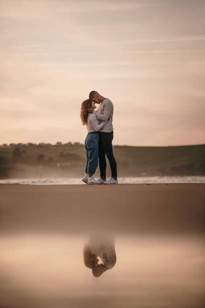 istock Young couple at beach and reflection 1281105005