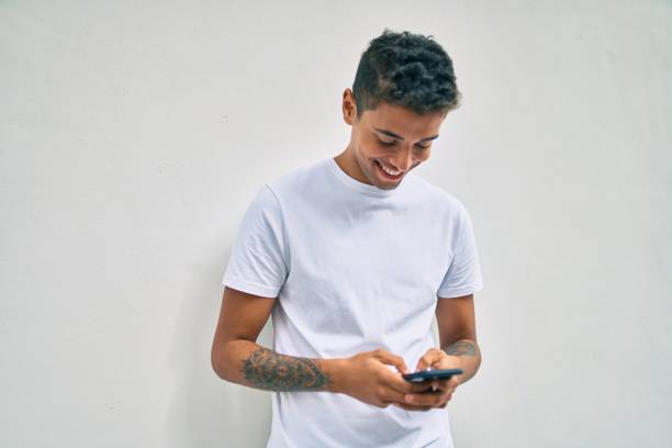 istock Young latin man smiling happy using smartphone walking at the city. 1281105292