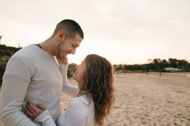 istock Young couple at a beach at sunset 1281106944