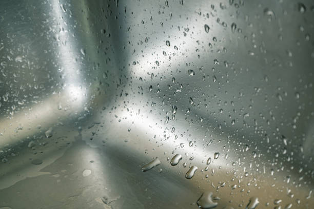 Texture of stainless steel kitchen sink with droplets