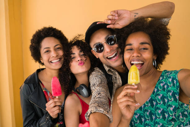 istock Multi-ethnic group of friends enjoying summertime while eating ice cream. 1281108630