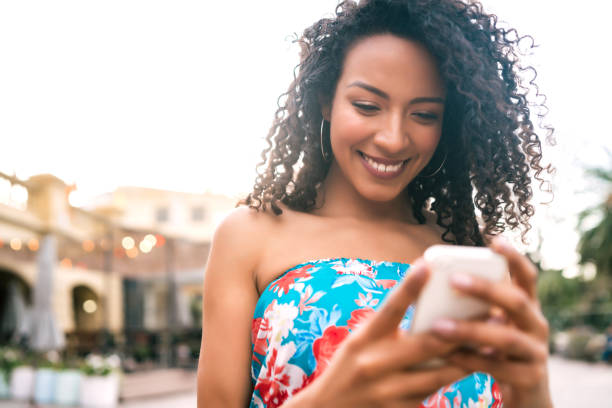 istock Afro American latin woman using mobile phone. 1281108659