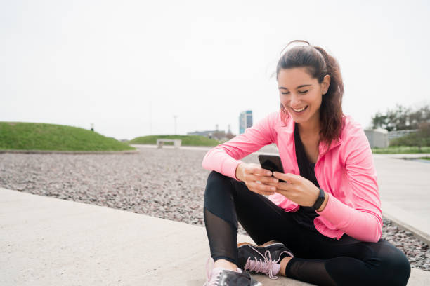 istock Athletic woman using her phone. 1281108697