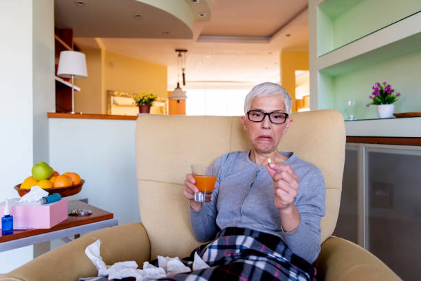 istock Senior woman taking medicine 1281108764