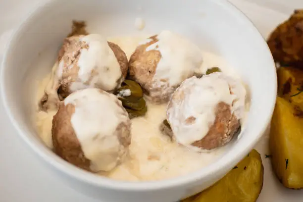 View of Koenigsberger klops, "na specialty traditional german style cooked meat balls in Kaliningrad, Kaliningrad Oblast, Russia, served with mashed potatoes in a white sauce