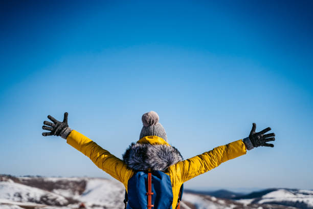 istock Woman with open arms on snowy mountain 1281110744