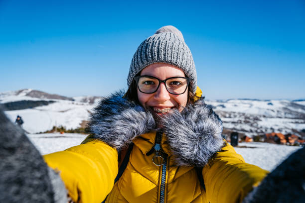 istock Woman making selfie on snowy mountain 1281110866