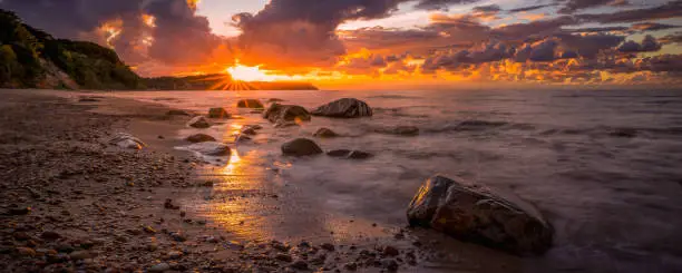 Colorful sunset over the sea and rocky shoreColorful sunset above the sea, harmony and tranquility