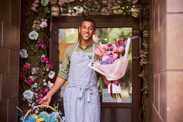 istock Kind mixed-race worker carrying flowers in both hands 1281112438