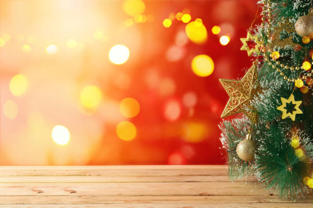 istock Christmas holiday background with Christmas tree and empty wooden table over festive bokeh 1281112604