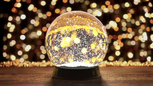 Glass snow globe with flying snowflakes on the background of christmas lights