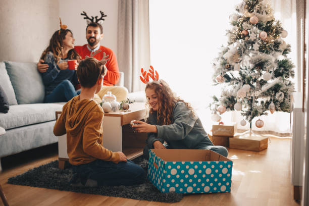 istock Children picking Christmas ornaments, while their parents drink warm beverage. 1281112876