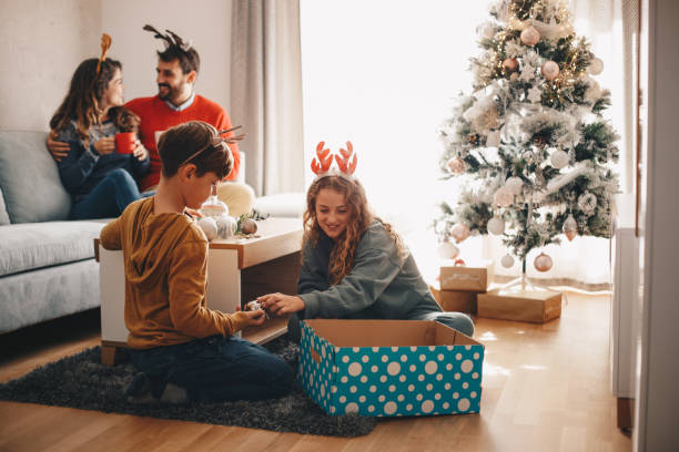 istock Children enjoying Christmas with their parents. 1281112880