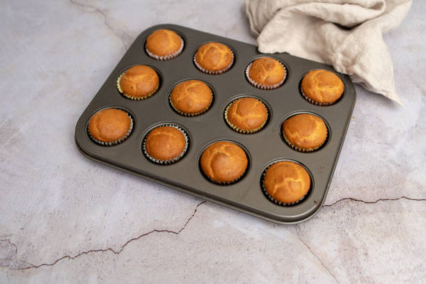 istock Mini muffins in paper cupcake holder and baking tray 1281117763