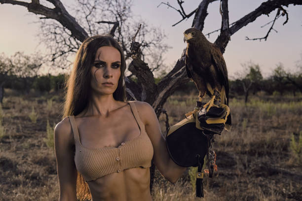 istock Beautiful woman posing on nature with eagle 1281119160