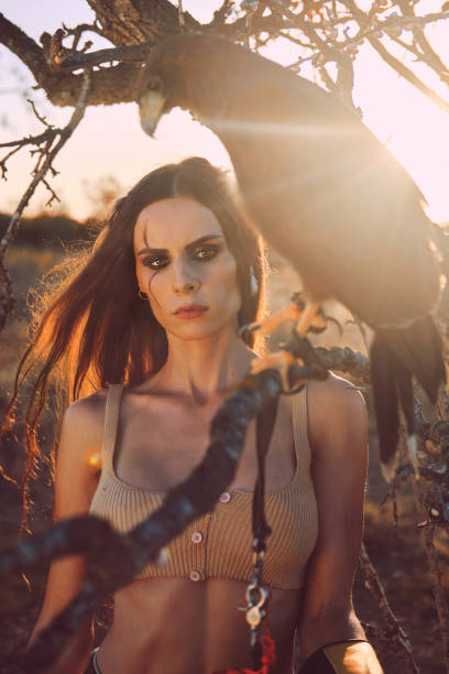 istock Beautiful woman posing on nature with eagle 1281119187