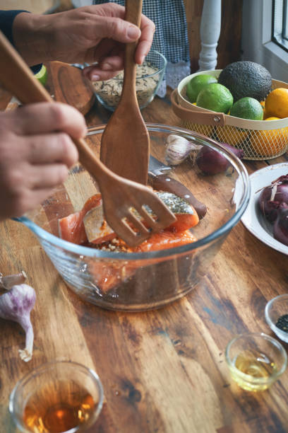 istock Preparing Spicy Salmon Bowl with Rice, Carrots, Cucumber and Avocado 1281119475