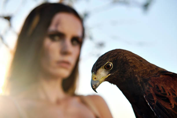 istock Beautiful woman posing on nature with eagle 1281119620
