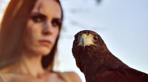 istock Beautiful woman posing on nature with eagle 1281119640