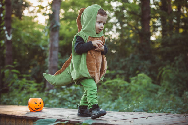 istock Baby boy in dinosaur costume 1281121527