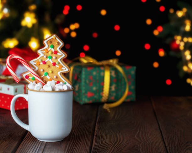istock Homemade Christmas gingerbread cookie, Xmas candy cane and cup with marshmallow on rustic wooden table. 1281121822