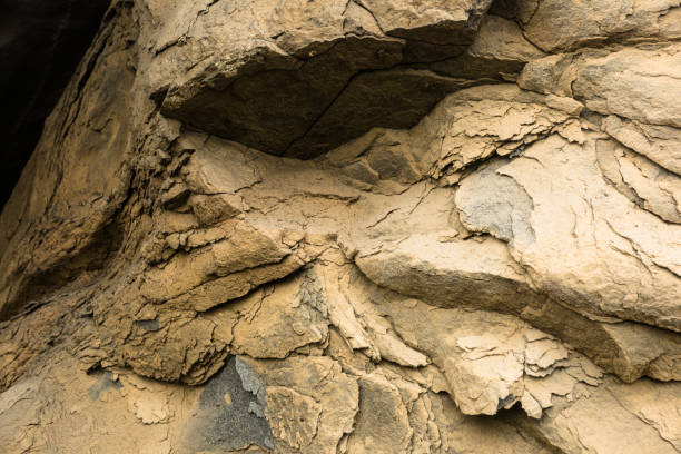 Fragment of a mountain with beautiful textural shapes for your design. Black rock background.