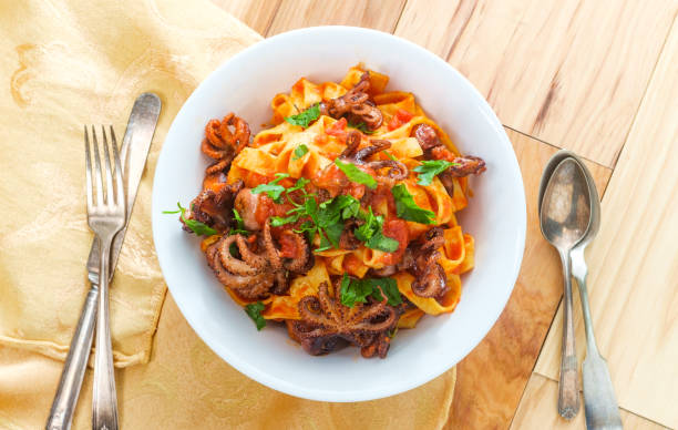 Italian Octopus Tagliatelle Italian tagliatelle con polpo grilled Octopus in tomato spaghetti sauce marinara stock pictures, royalty-free photos & images