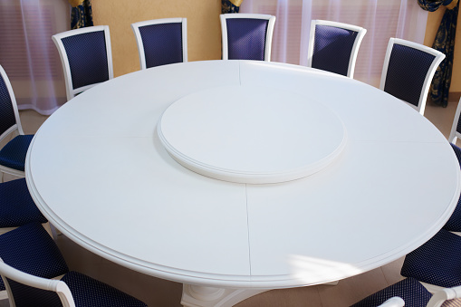 Empty white round conference table and chairs. Resolving conflicts and problems through diplomatic means.
