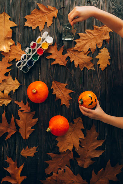 istock Child paints pumpkins for Halloween 1281124672