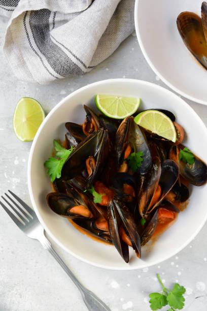 istock Mussels in tomato sauce with lime and parsley 1281125475