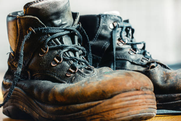 istock Old worn-out workman's shoes. Shoes that require repair or replacement 1281125677